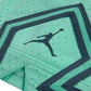Pantaloncini da basket Jordan Diamond Kids teal, pantaloncino sportivo per bambini, con logo Jordan visibile.